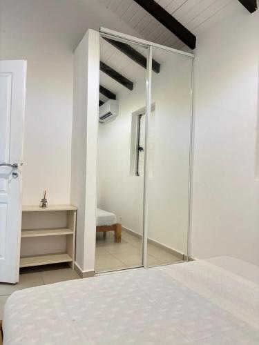a bedroom with a sliding glass door with a bed at Saka Lodge in Le Gosier