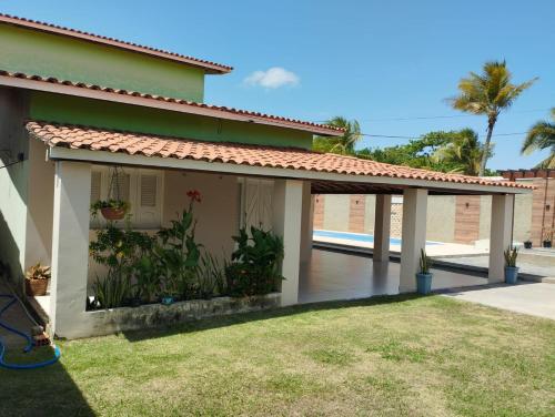 a house with a pergola and a patio at Residência Lençóis Pousada in Barreirinhas