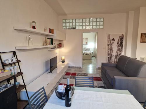 a living room with a couch and a table at Grosseto Design Apartment in Grosseto