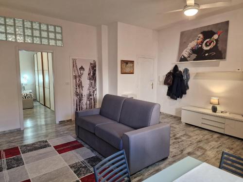 a living room with a couch and a table at Grosseto Design Apartment in Grosseto