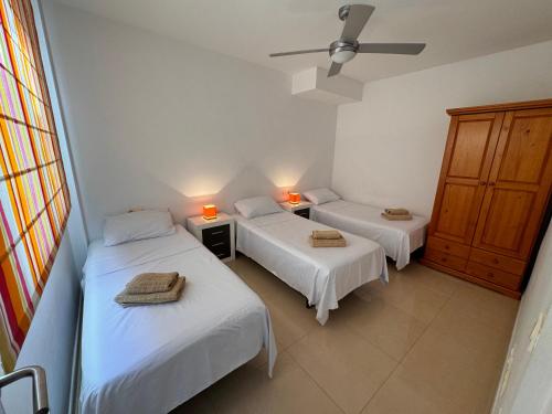 two beds in a room with two lights on at Heavenly Homes Mojacar 73 in Mojácar