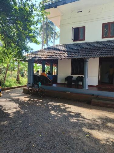 a house with a bike parked in front of it at Perch Next door in Kannur