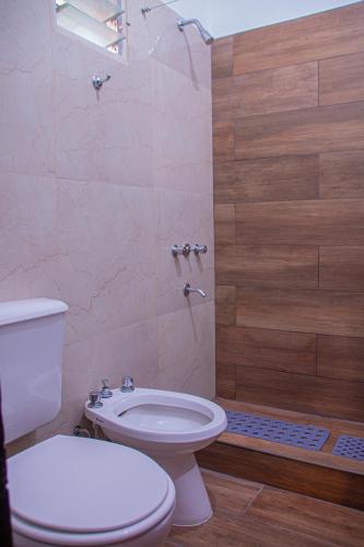 a bathroom with a toilet and a shower at Tilcara Hostal Niña Coya in Tilcara
