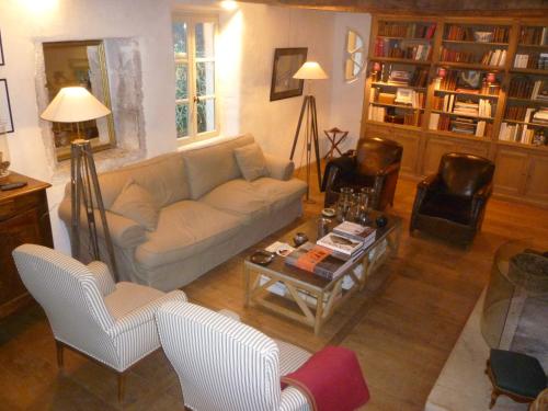 a living room with a couch and a coffee table at Le Mas de Laval in Saint-Cirq-Lapopie