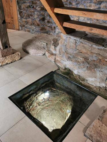 a pool of water in front of a stone wall at Вила 'Гнездото', Villa 'The nest', Rhodope mountains, Banite in Vishnevo