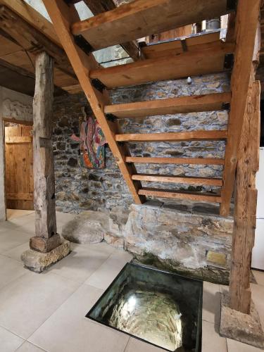 a fireplace in a room with a stone wall at Вила 'Гнездото', Villa 'The nest', Rhodope mountains, Banite in Vishnevo