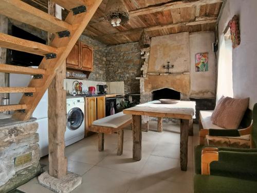 a kitchen with a table and a washing machine at Вила 'Гнездото', Villa 'The nest', Rhodope mountains, Banite in Vishnevo