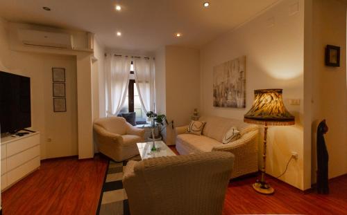 a living room with a couch and a table at B&B Apartments Coli Apatrman Viola Self check on the Ground floor in Bakar