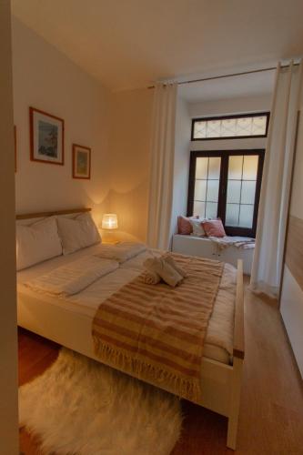 a bedroom with a large bed and a window at B&B Apartments Coli Apatrman Viola Self check on the Ground floor in Bakar