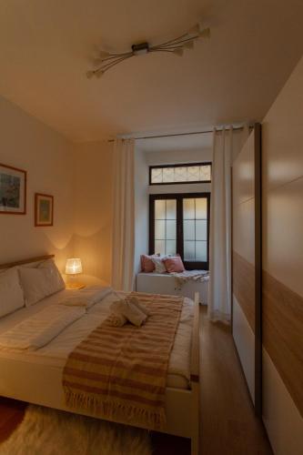 a bedroom with a large bed and a window at B&B Apartments Coli Apatrman Viola Self check on the Ground floor in Bakar