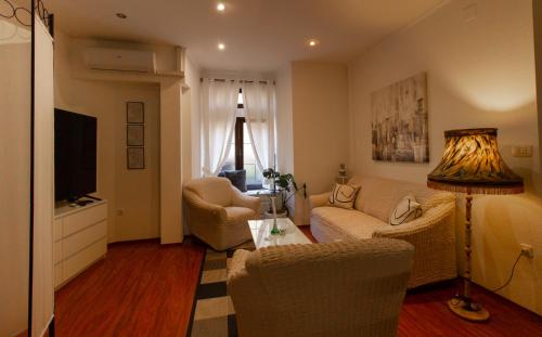 a living room with a couch and chairs and a television at B&B Apartments Coli Apatrman Viola Self check on the Ground floor in Bakar