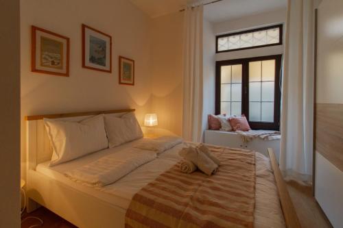 a bedroom with a large bed and a window at B&B Apartments Coli Apatrman Viola Self check on the Ground floor in Bakar