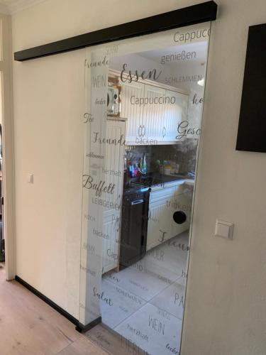 a sliding glass door with writing on the wall at Murmelbau in Kiefersfelden