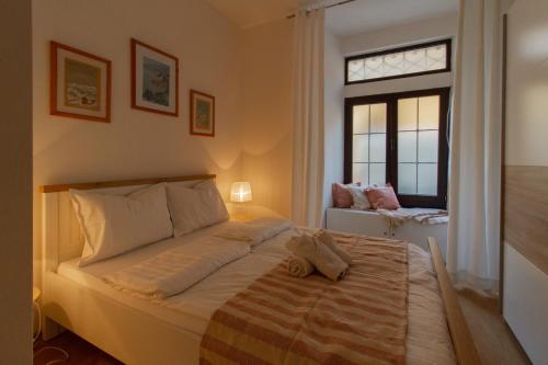 a bedroom with a large bed and a window at B&B Apartments Coli Apatrman Viola Self check on the Ground floor in Bakar