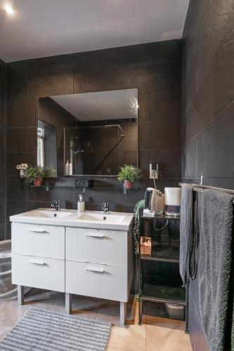 a bathroom with a white sink and a mirror at denis salvà montjuic in Barcelona