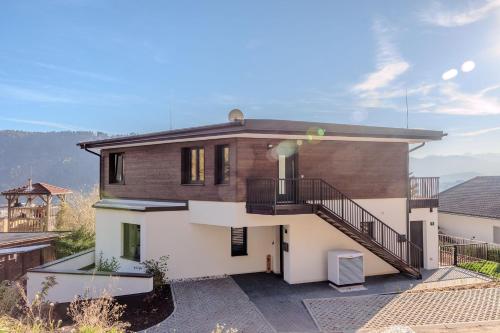 a house with a staircase on the side of it at Adlerblick Deluxe Annenheim in Annenheim