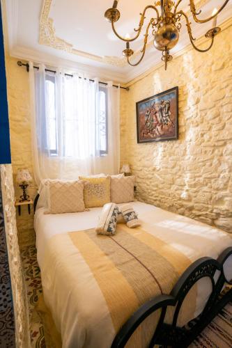 a bedroom with a large bed in a room at Dar AL GHAZAL in Tangier