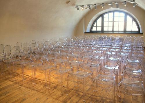a row of empty chairs in a room at Rothko Museum residences in Daugavpils