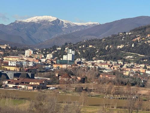 a view of a city with mountains in the background at Friends and Family in Brescia