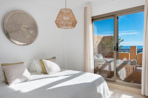 a bedroom with a bed and a window with a view at Premium Penthouse with Unmatched Views in Estepona