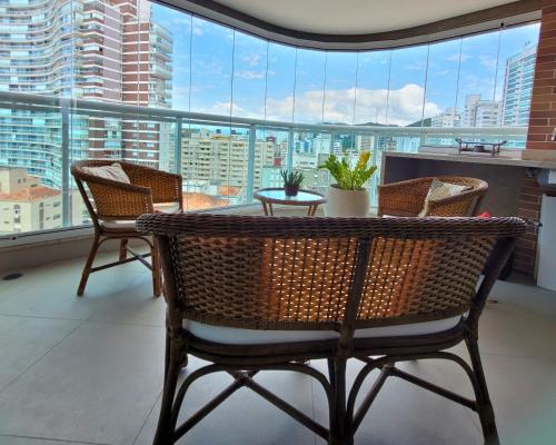 a table and chairs in a room with a large window at BookSantos Estanconfor 1601 Vista Incrível do apê in Santos
