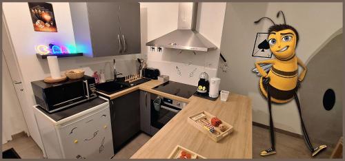 a kitchen with a cartoon figure standing in a kitchen at 15' de Disney maison à thème avec SALLE DE JEUX privée 6 couchages 2 wc in Voulangis