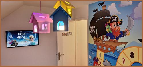 a childs room with a wall mural of a disney movie at 15' de Disney maison à thème avec SALLE DE JEUX privée 6 couchages 2 wc in Voulangis