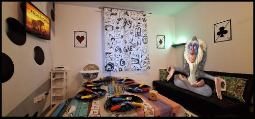a room with a couch with a table in it at 15' de Disney maison à thème avec SALLE DE JEUX privée 6 couchages 2 wc in Voulangis