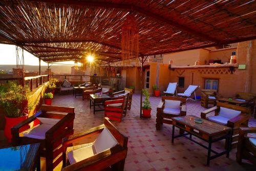 a restaurant with tables and chairs on a patio at Kasbah El Hajja in Aït Benhaddou