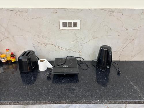 a counter with two toasters and a printer on it at Yb home2 in Rāthdhana