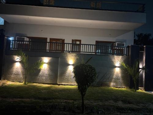 a house with a balcony at night with lights at Yb home2 in Rāthdhana