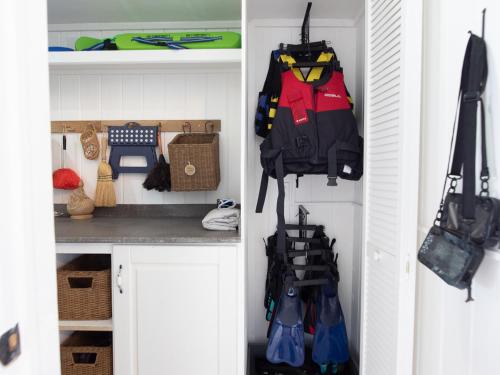 a closet withpacks and bags hanging from the wall at The Seahouse Antigua SEAFRONT in Bats Cave