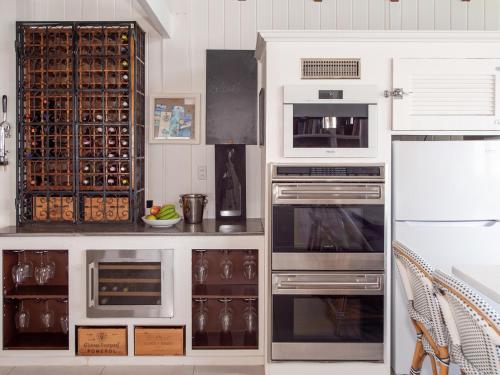 a kitchen with stainless steel appliances and white cabinets at The Seahouse Antigua SEAFRONT in Bats Cave