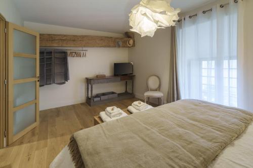 a bedroom with a large bed and a window at Gîte 1694 - 4 étoiles - proche Futuroscope in Scorbé-Clairvaux