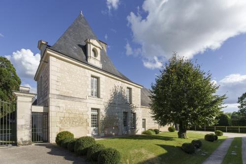 an old stone church with a clock tower at Gîte 1694 - 4 étoiles - proche Futuroscope in Scorbé-Clairvaux
