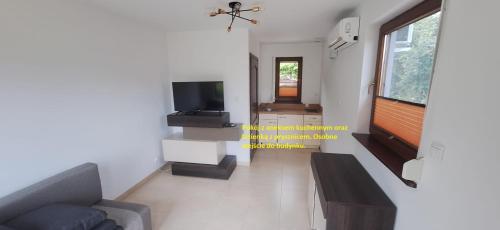 a living room with a couch and a tv at MB House Sarbinowo in Sarbinowo