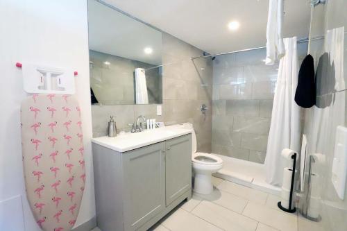 a bathroom with a sink and a toilet and a shower at Ocean Drive Rooftop Suite with Ocean Views & Terrace in Miami Beach