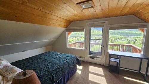 a bedroom with a bed and a large window at Palmers Dr 1010 in Silverthorne
