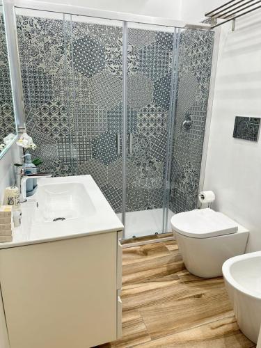 a bathroom with a shower and a toilet and a sink at Ines Apartments in Giardini Naxos