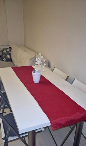 a table with a red and white table cloth on it at Apartman Kinder in Pale