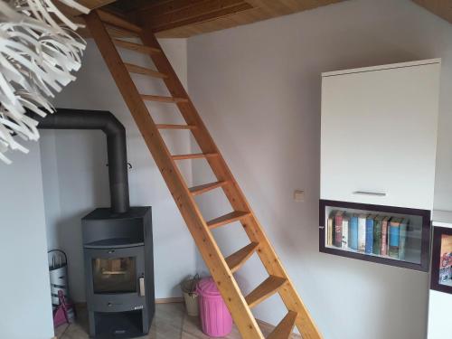a wooden ladder next to a stove in a room at Wohnung Auerand in Nienhagen
