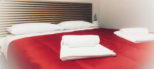 a large bed with white sheets and towels on it at La cas d' Taton in Pratola Peligna