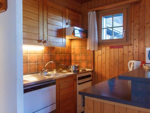a kitchen with a sink and a stove at Apartment Edelweiss by Interhome in Champoussin