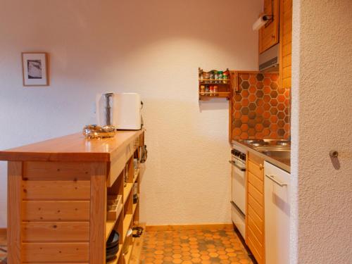 a small kitchen with a counter and a sink at Apartment Dahlia by Interhome in Champoussin