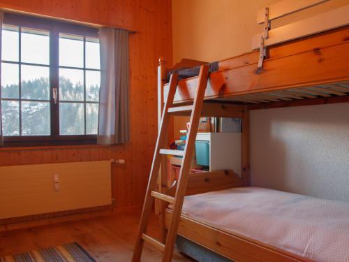 a bedroom with two bunk beds and a window at Apartment Dahlia by Interhome in Champoussin