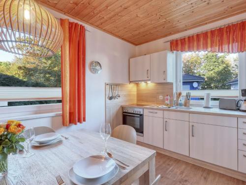 a kitchen with a table and a dining room at Holiday Home Möwennest by Interhome in Altefähr