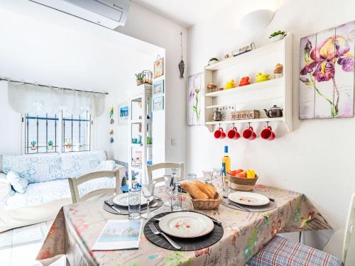 a dining room with a table with plates of food on it at Holiday Home Les Parcs de Gassin-1 by Interhome in Saint-Tropez