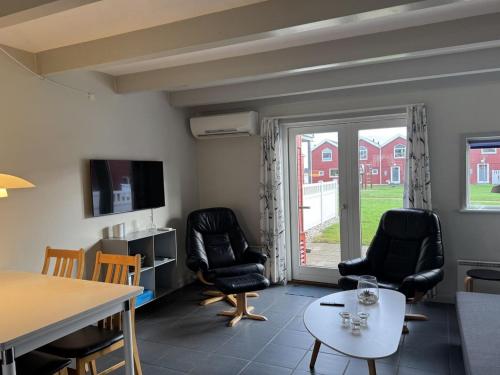a living room with two chairs and a table at Apartment Arton - from the sea by Interhome in Hadsund