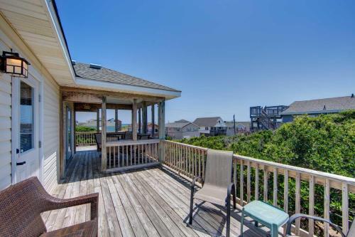 a porch with two benches on a house at Porch Song in Kitty Hawk