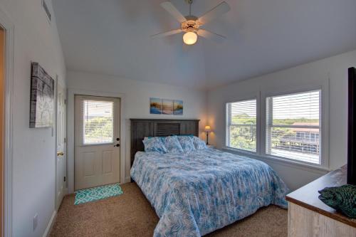 a bedroom with a bed and a ceiling fan at Porch Song in Kitty Hawk